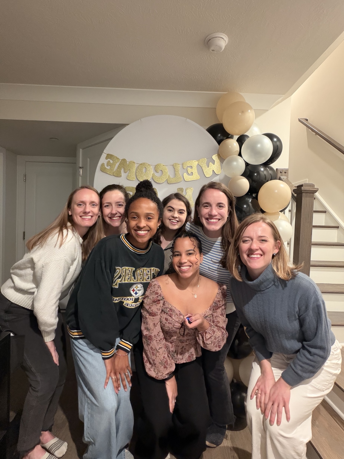 A group of women smiling together at a thoughtfully styled gathering